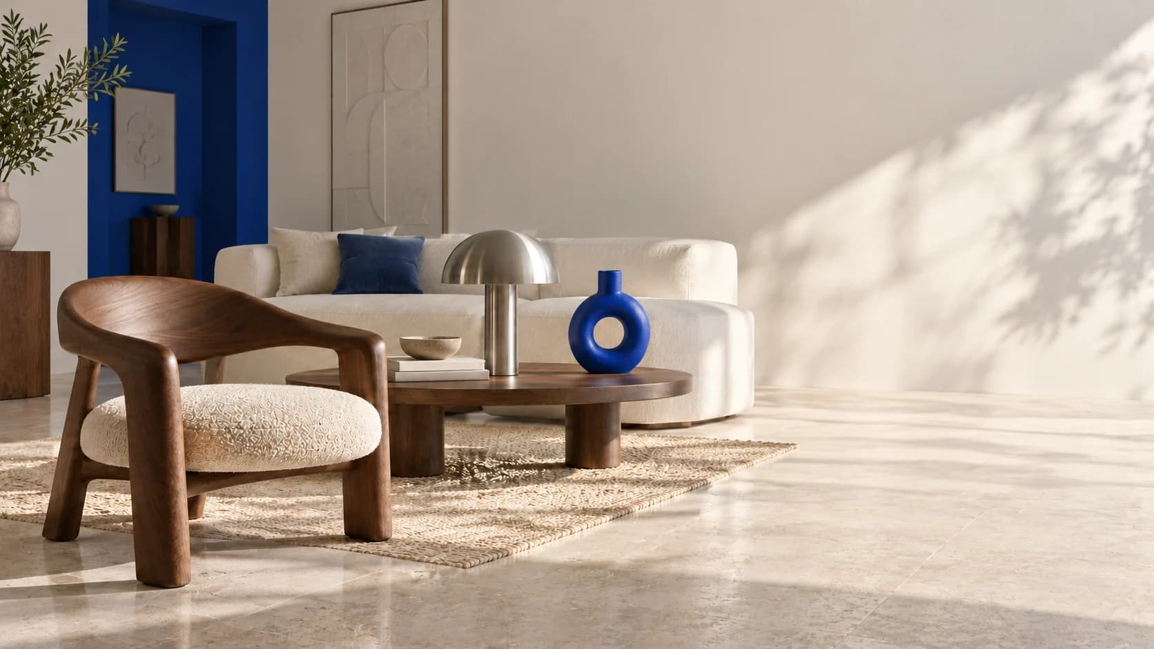 A sunlit room with walnut furniture, ecru upholstery and a cobalt doorway